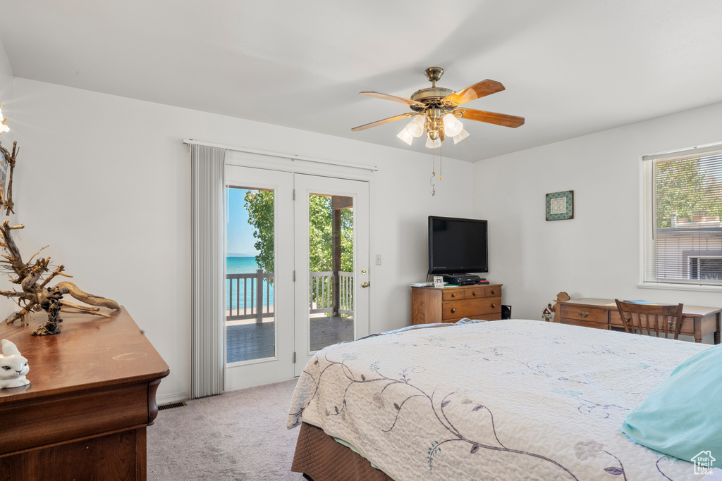 Bedroom with access to exterior, carpet flooring, and ceiling fan