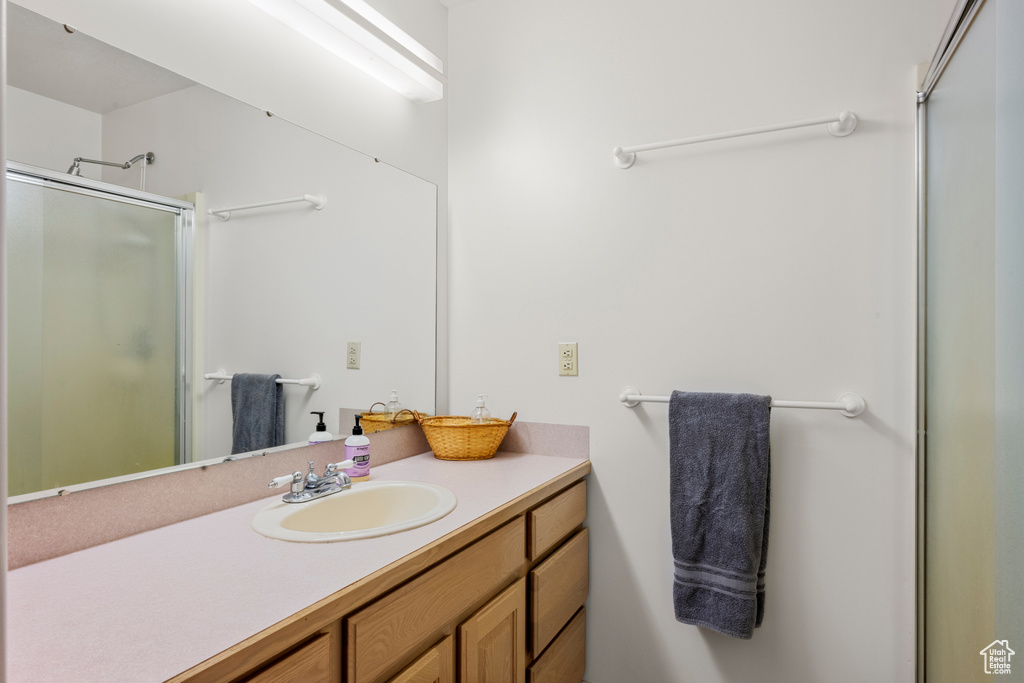 Full bathroom featuring a shower stall and vanity