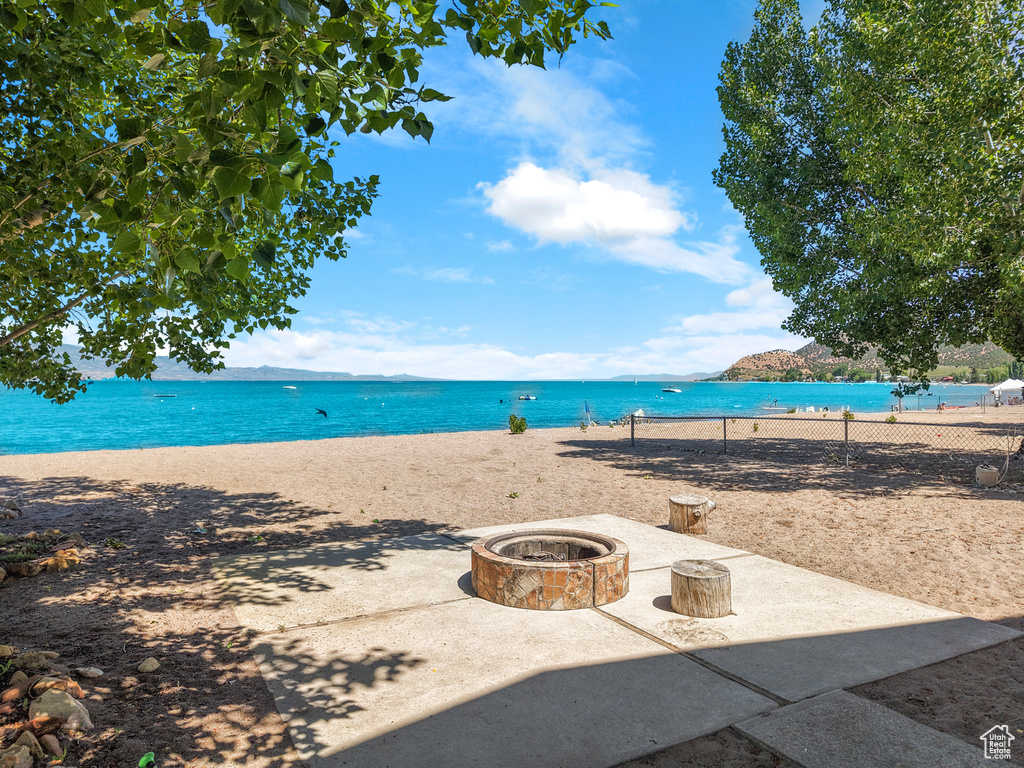 Water view featuring a fire pit and nearby beach
