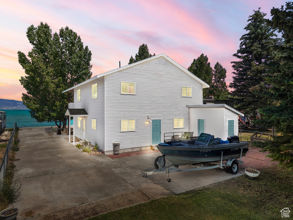 Rear view of house featuring a patio area and concrete driveway