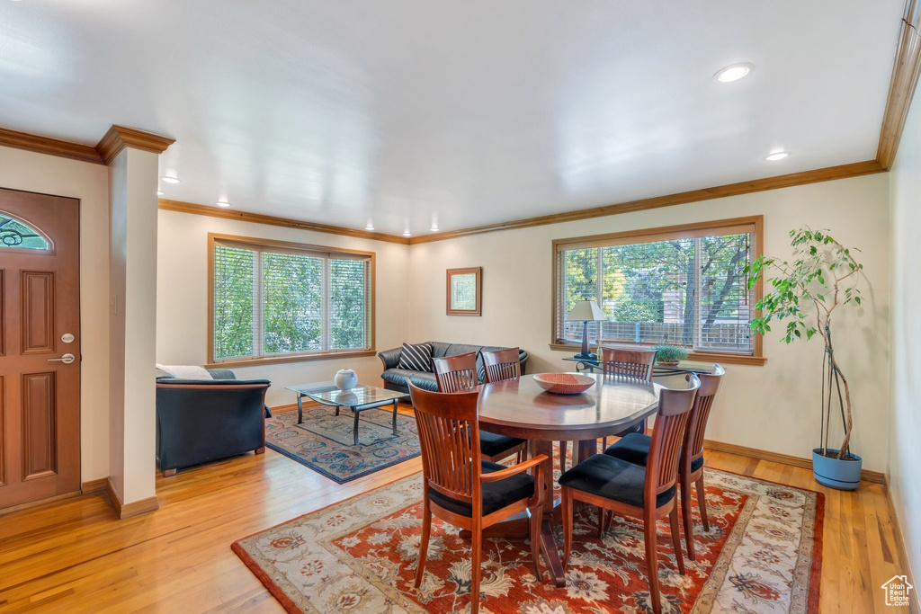 Dining area featuring plenty of natural light, ornamental molding, light wood-type flooring, and recessed lighting