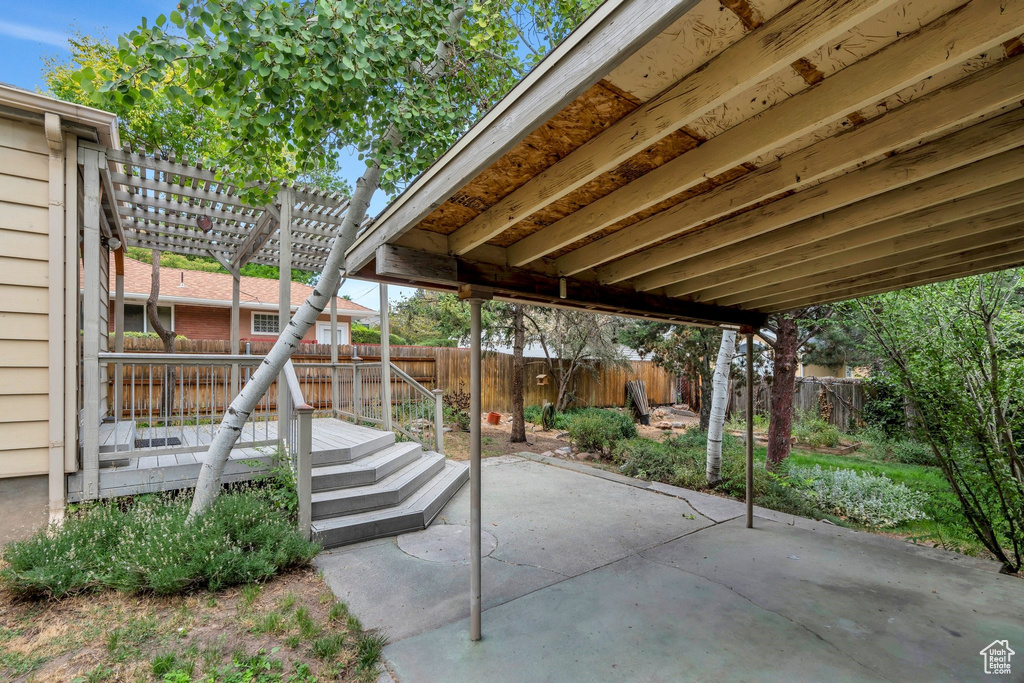 Fenced backyard with a pergola and a patio