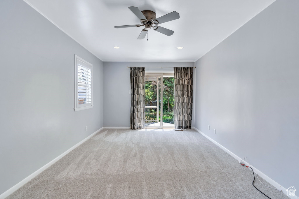 Carpeted spare room with plenty of natural light, ceiling fan, and recessed lighting