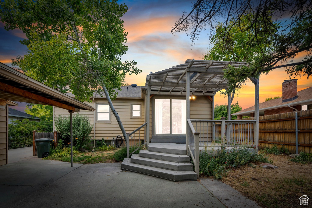 Rear view of house featuring a pergola and a patio area