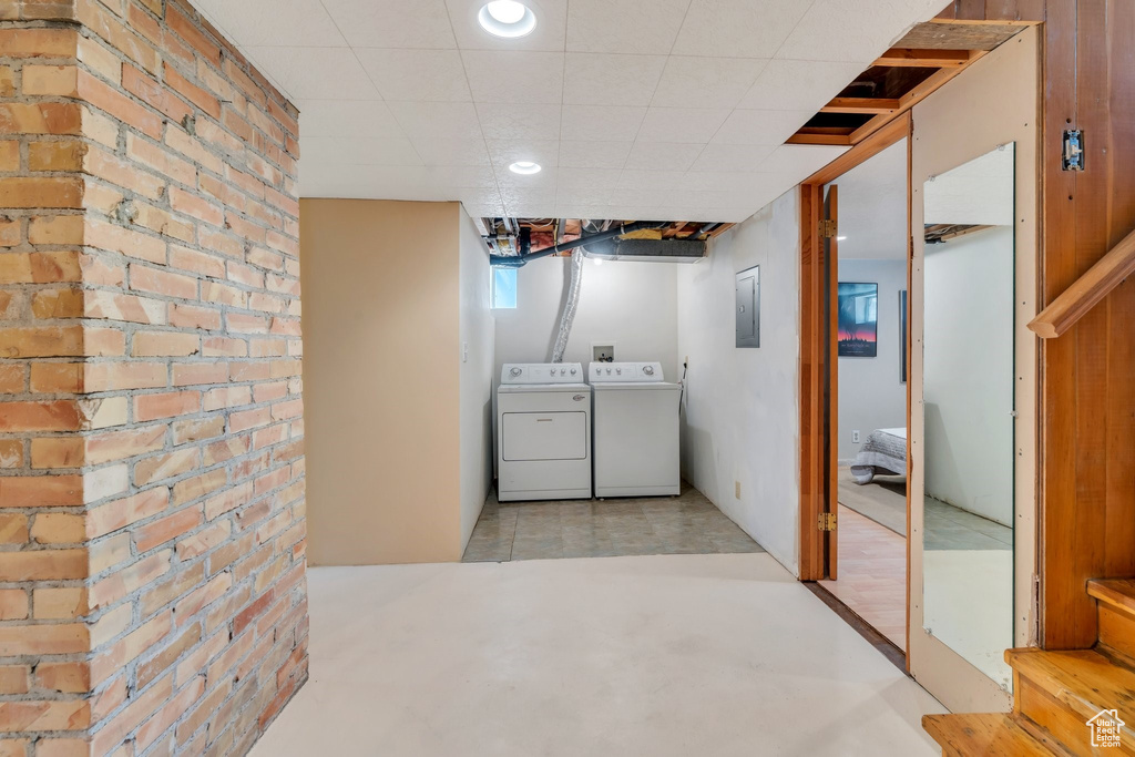 Laundry area featuring independent washer and dryer and electric panel