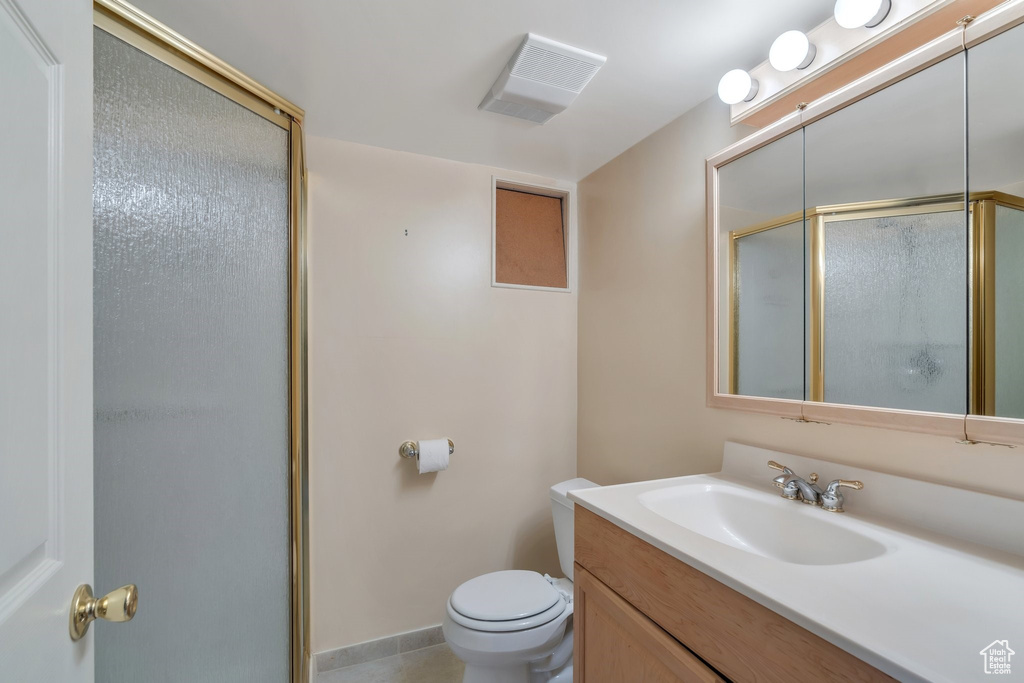 Bathroom with a shower stall and vanity