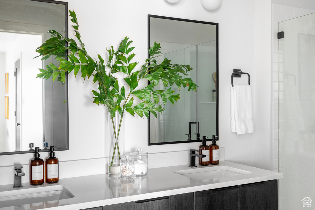 Bathroom featuring vanity and a shower stall