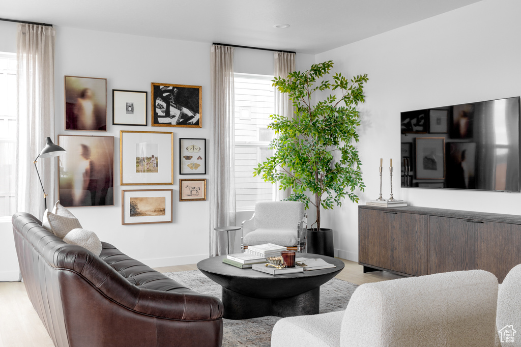 Living area with light wood-style flooring and baseboards