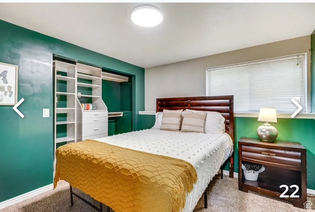 Carpeted bedroom featuring baseboards