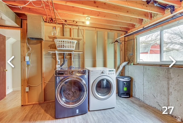 Laundry area featuring separate washer and dryer and wood finished floors
