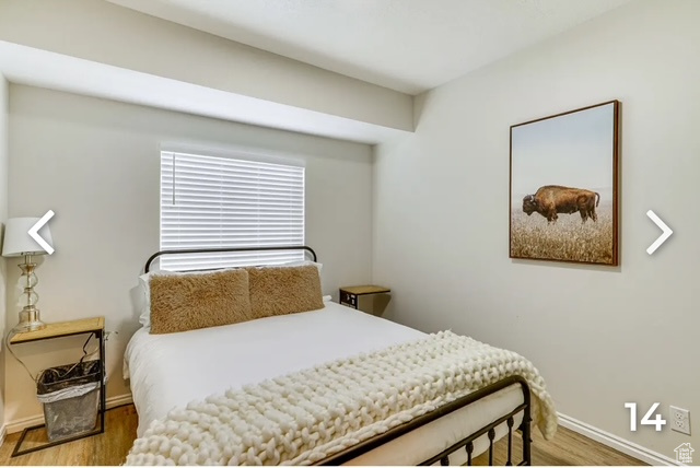Bedroom featuring wood finished floors and baseboards