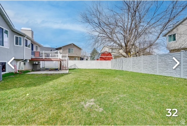 View of yard featuring a deck and stairs