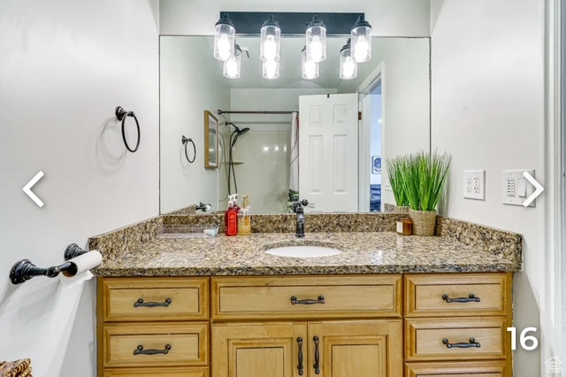 Bathroom with vanity and a shower