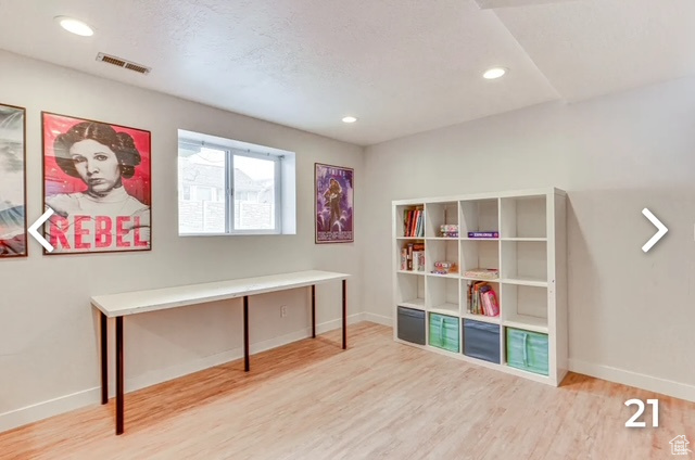 Unfurnished office with wood finished floors and recessed lighting