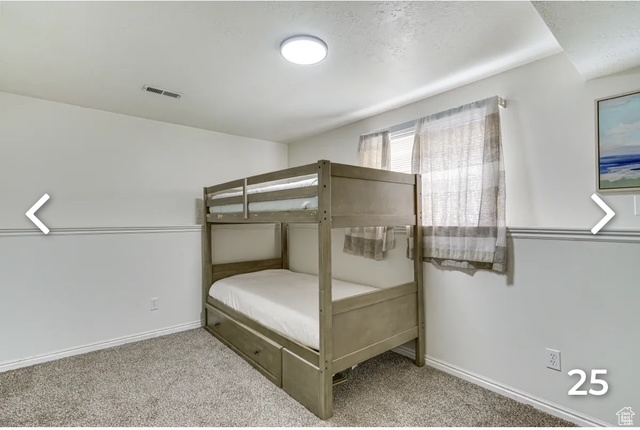 Bedroom featuring carpet floors and baseboards