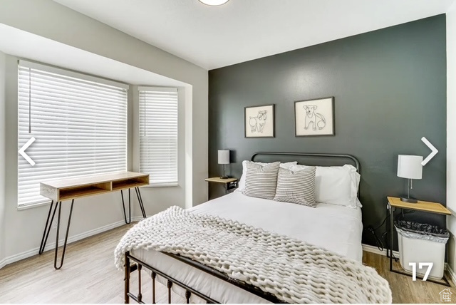 Bedroom featuring light wood-style floors and multiple windows
