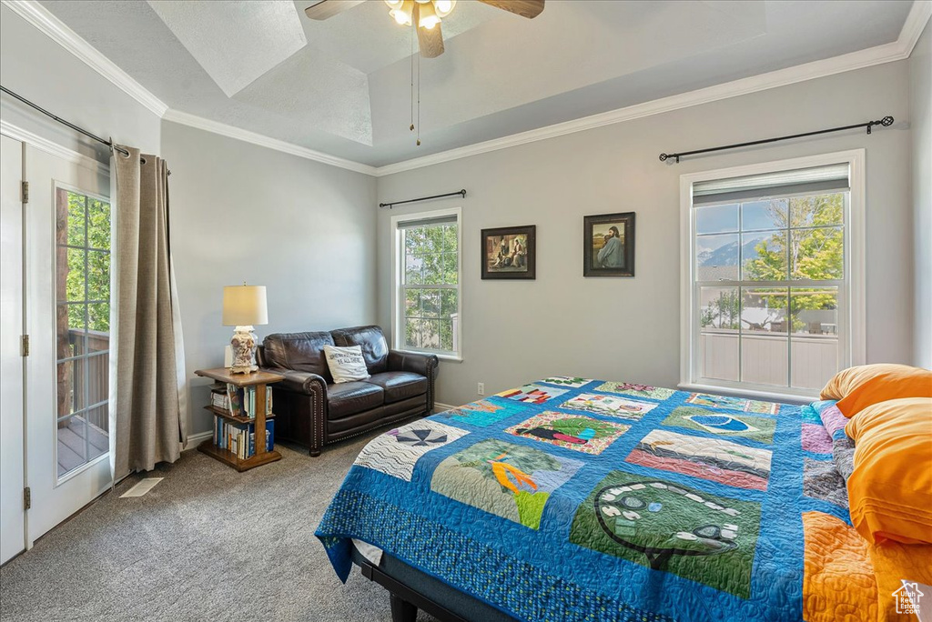 Bedroom featuring carpet floors, ornamental molding, and a ceiling fan