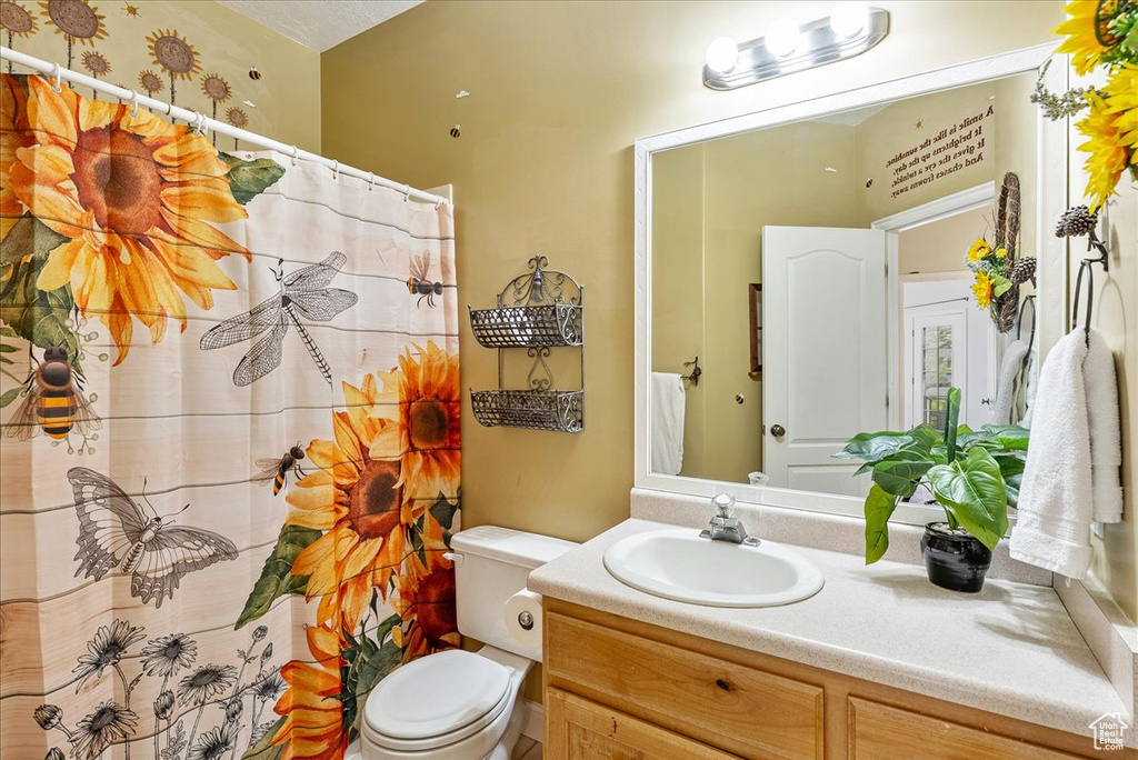 Bathroom with vanity and curtained shower