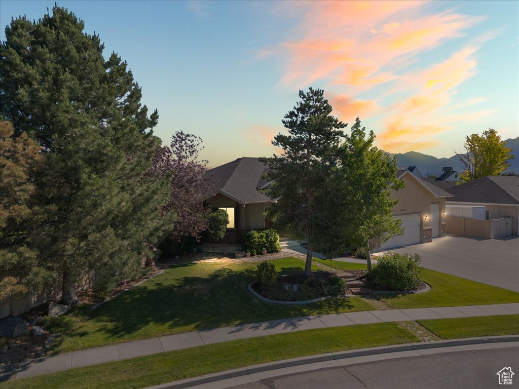 Obstructed view of property with driveway and an attached garage