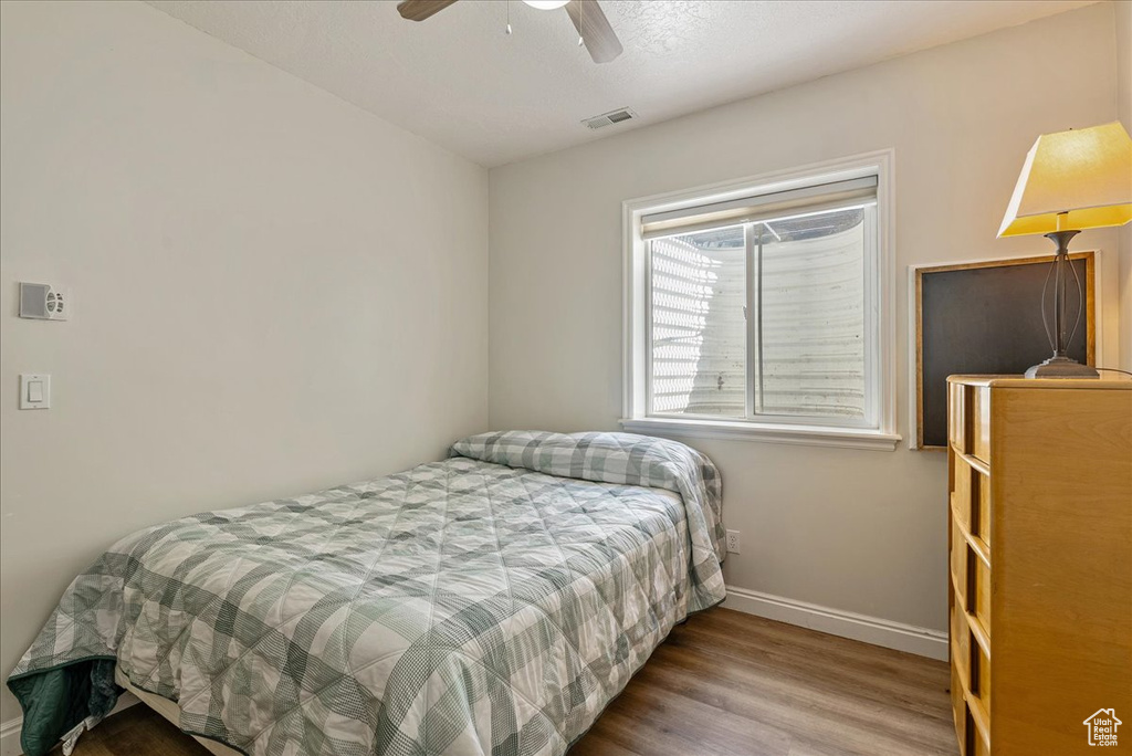 Bedroom featuring wood finished floors and ceiling fan