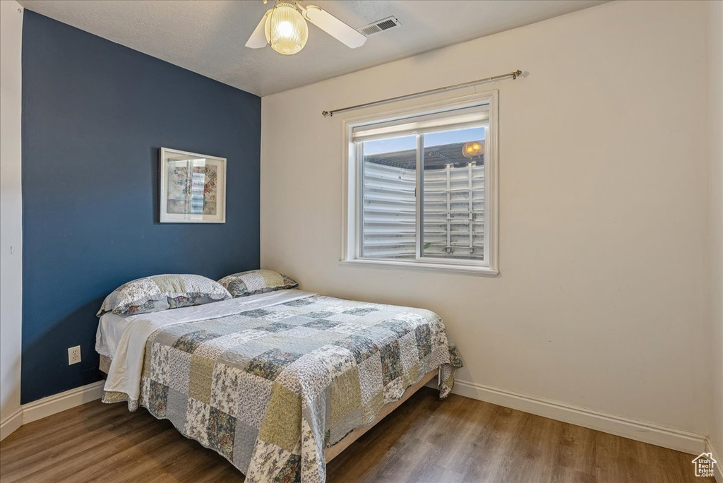 Bedroom with wood finished floors and ceiling fan