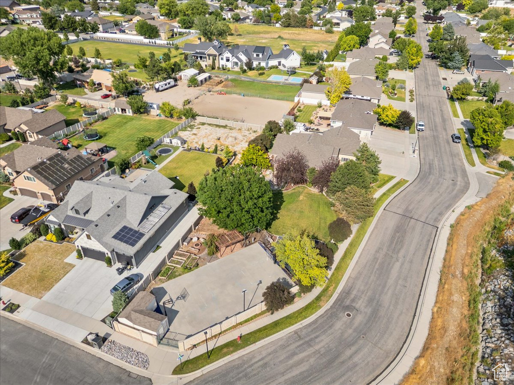 Aerial view of property and surrounding area featuring nearby suburban area
