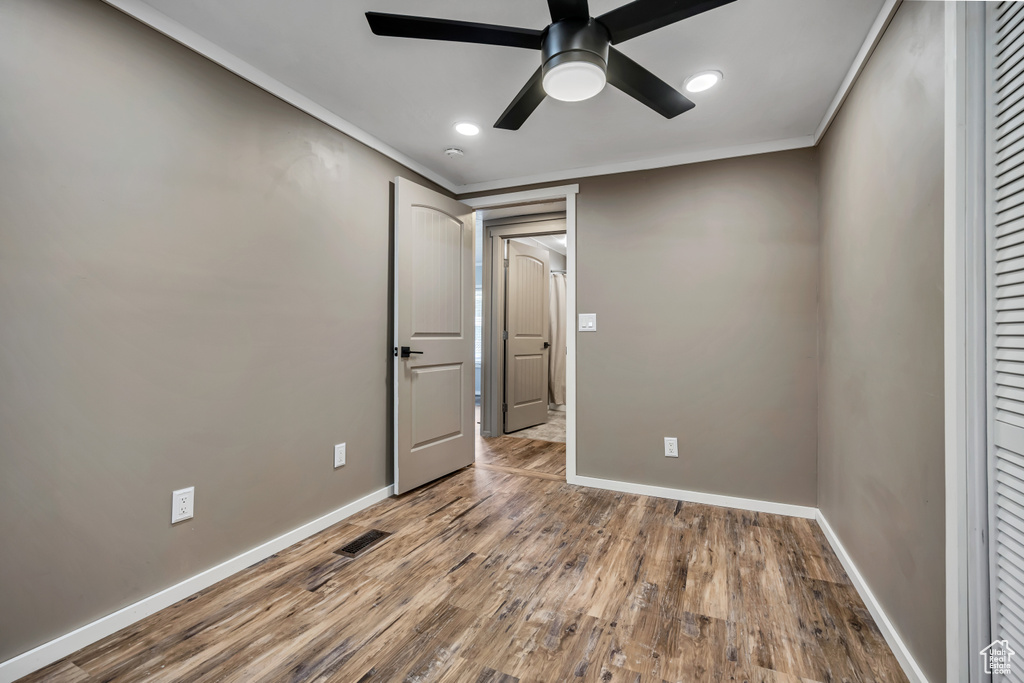 Unfurnished bedroom featuring wood finished floors, ornamental molding, recessed lighting, and ceiling fan