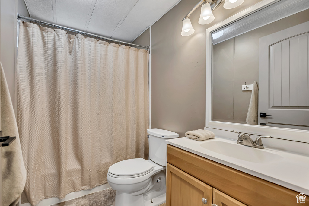 Full bath with toilet and vanity