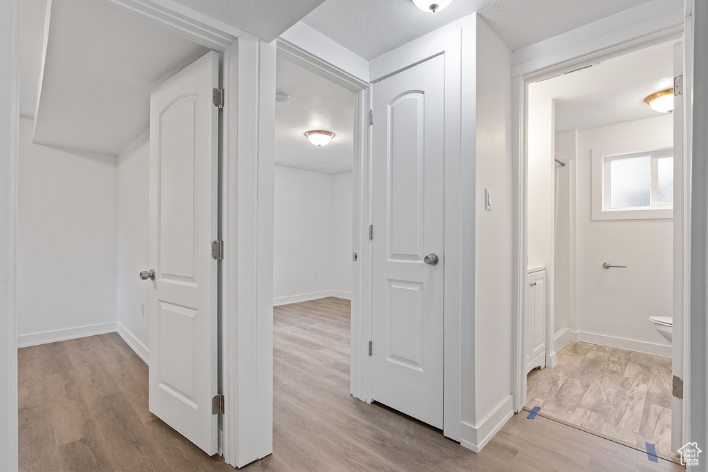 Hallway with light wood finished floors