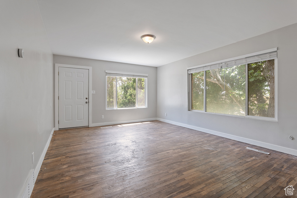 Spare room with hardwood / wood-style floors and baseboards