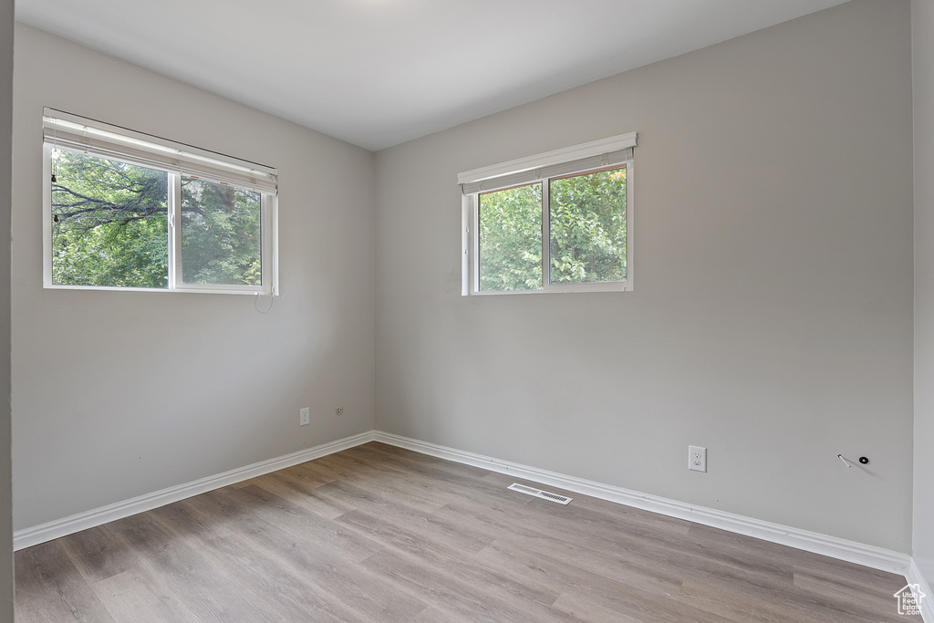 Unfurnished room with plenty of natural light and light wood-style floors