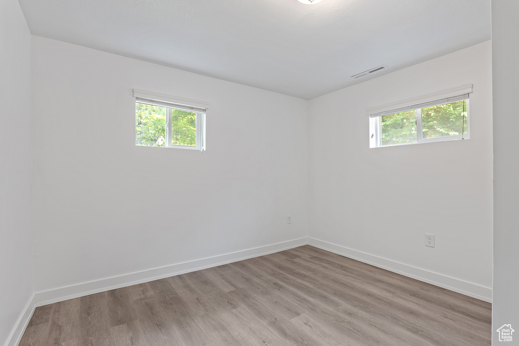 Unfurnished room featuring healthy amount of natural light and light wood-type flooring