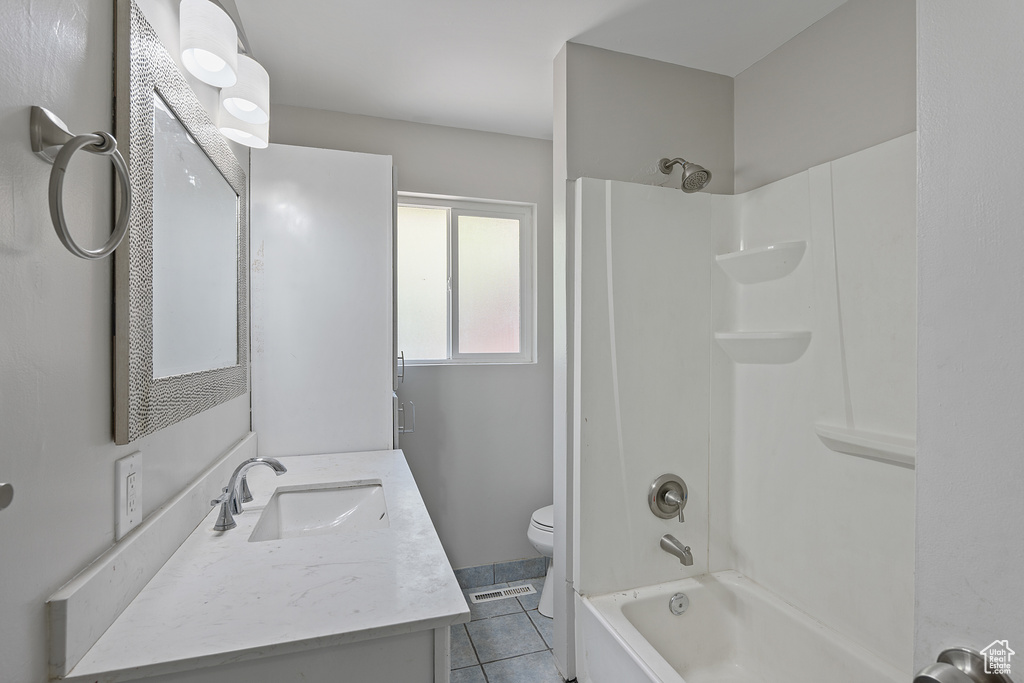 Full bathroom with vanity, shower / bathtub combination, and tile patterned flooring