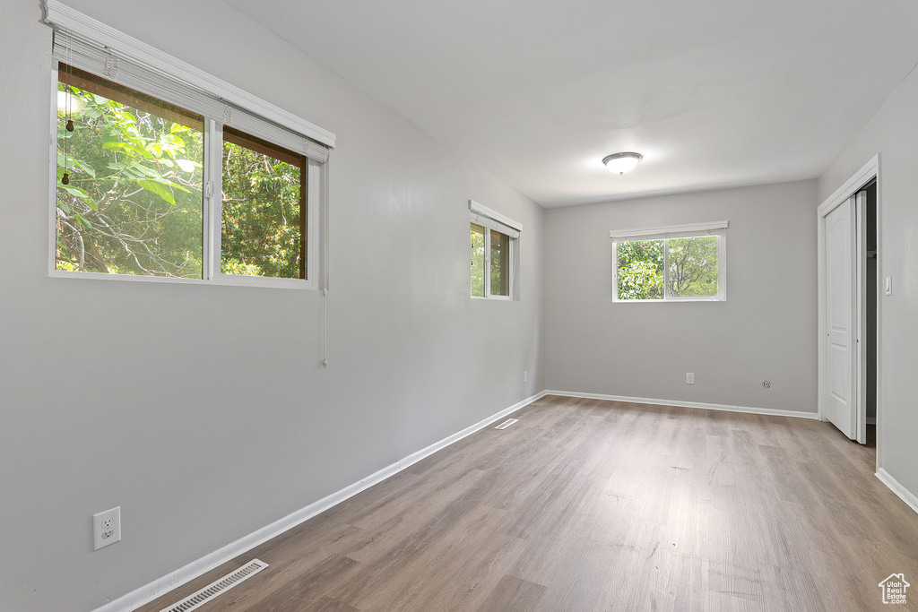 Unfurnished bedroom with wood finished floors and baseboards