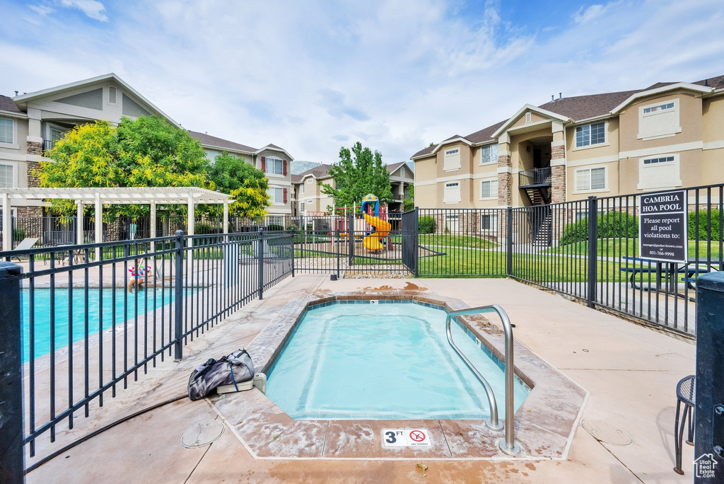 Community pool featuring a residential view and a pergola