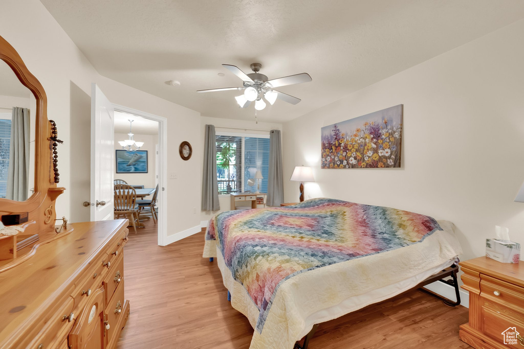 Bedroom with light wood-style floors and ceiling fan
