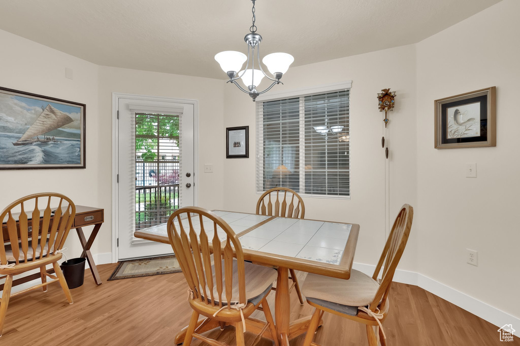 Dining room with a chandelier and light wood finished floors