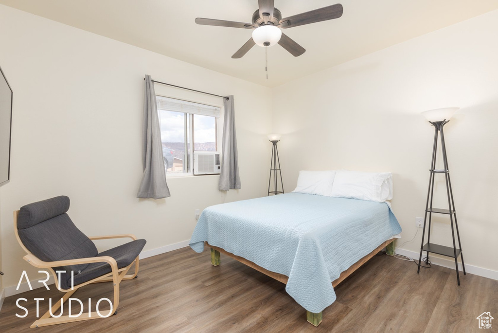 Bedroom featuring wood finished floors and a ceiling fan