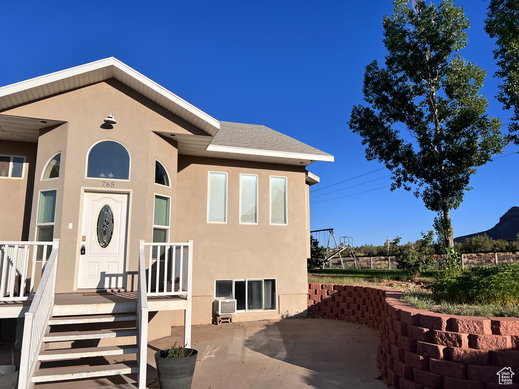 Entrance to property featuring stucco siding and a patio