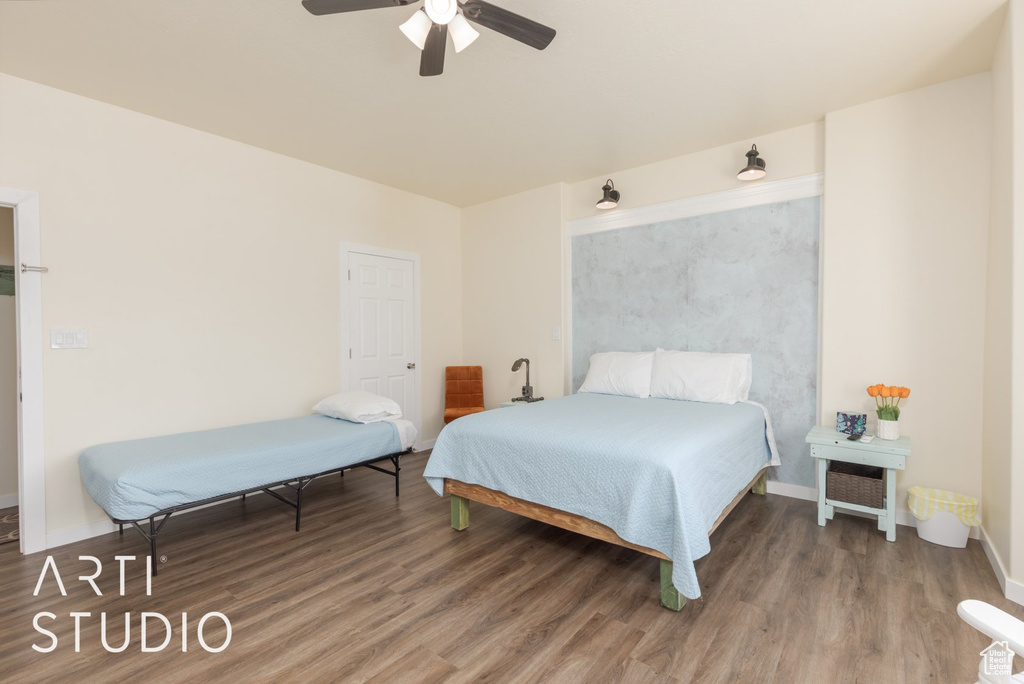 Bedroom featuring wood finished floors and a ceiling fan