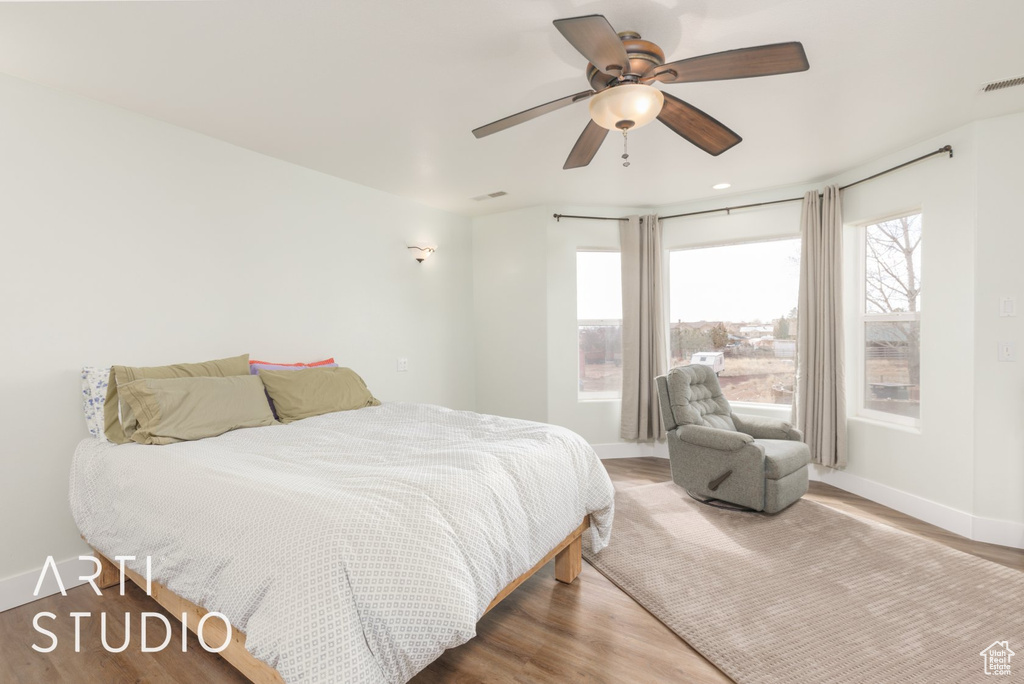 Bedroom with wood finished floors and a ceiling fan