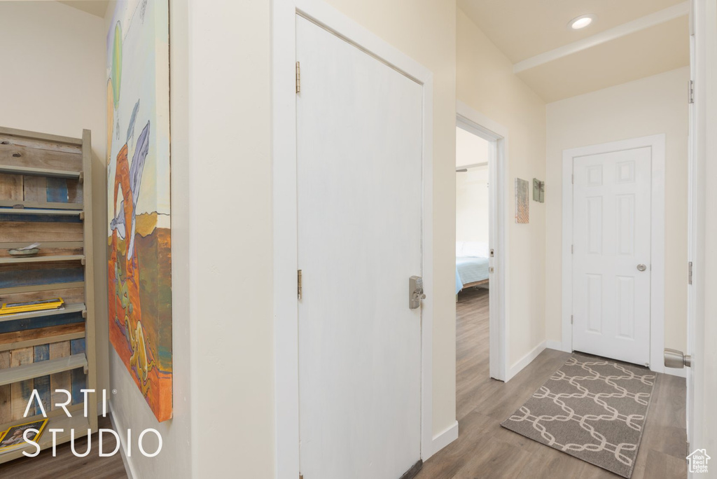 Hall with wood finished floors and baseboards