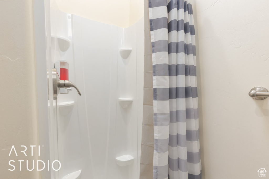 Bathroom featuring a shower with shower curtain