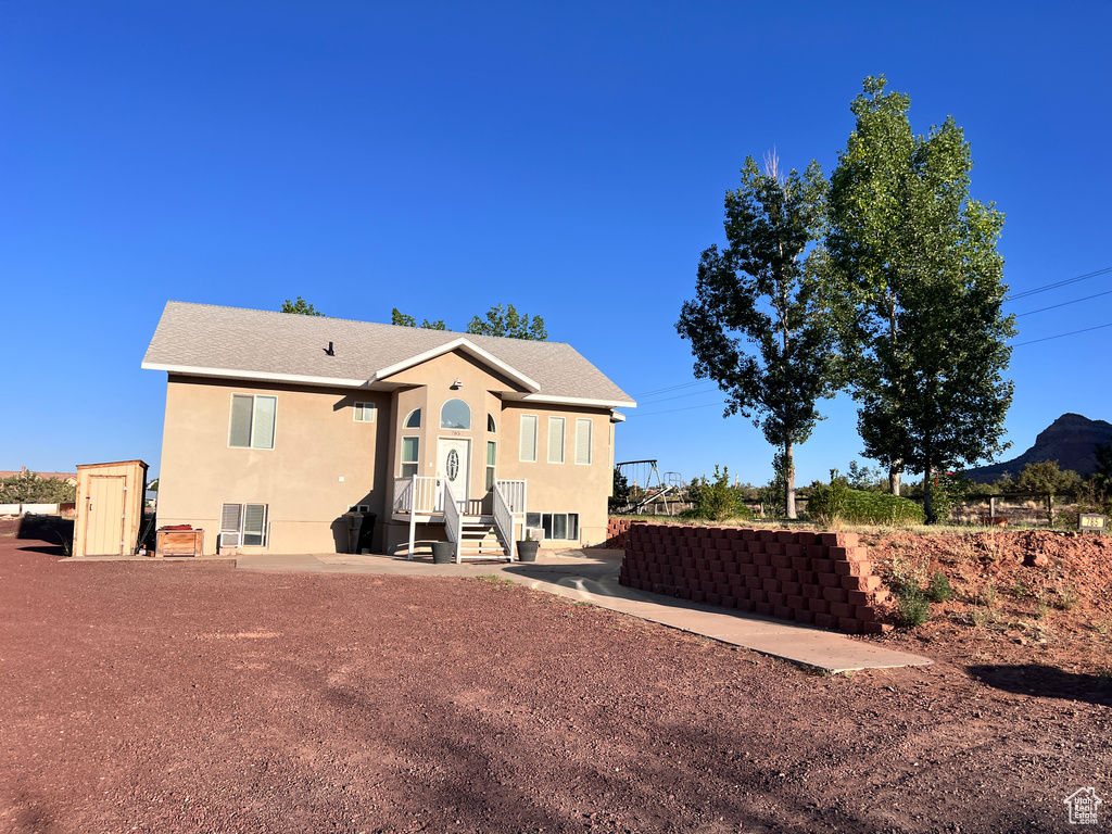 Back of house featuring stucco siding