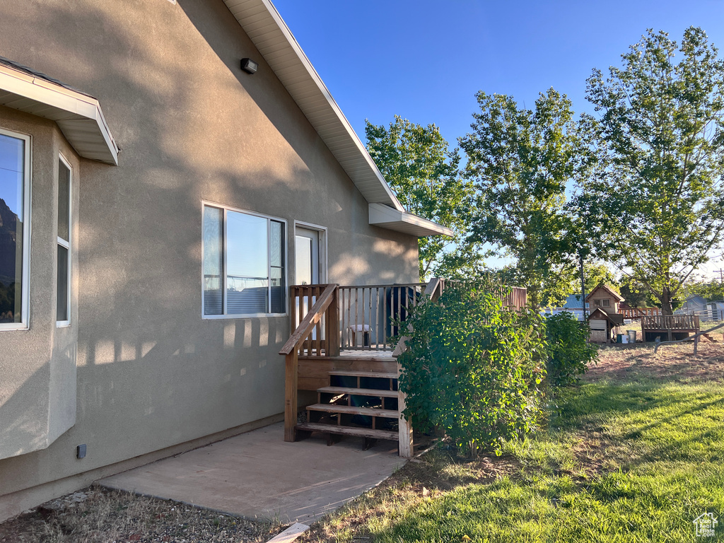 View of yard featuring a patio and a wooden deck