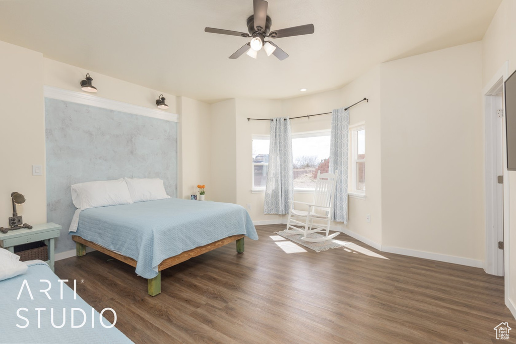 Bedroom with wood finished floors and a ceiling fan