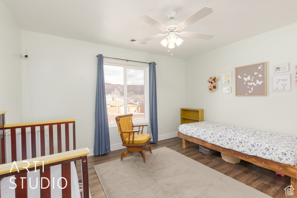 Bedroom with wood finished floors and a ceiling fan