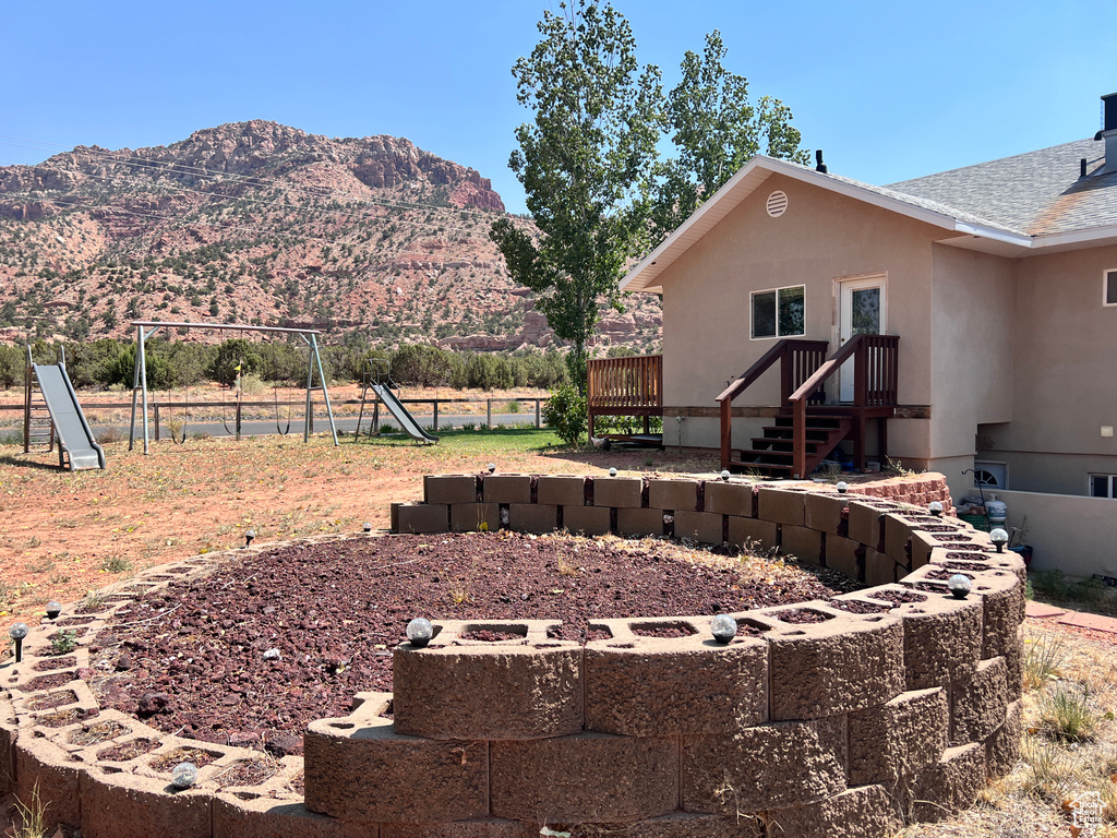 View of yard featuring a playground and a mountain view