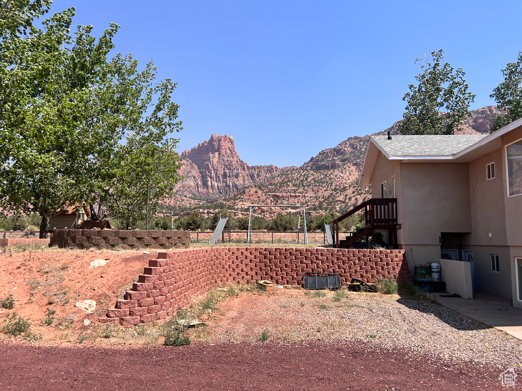 View of yard featuring stairs and a mountain view