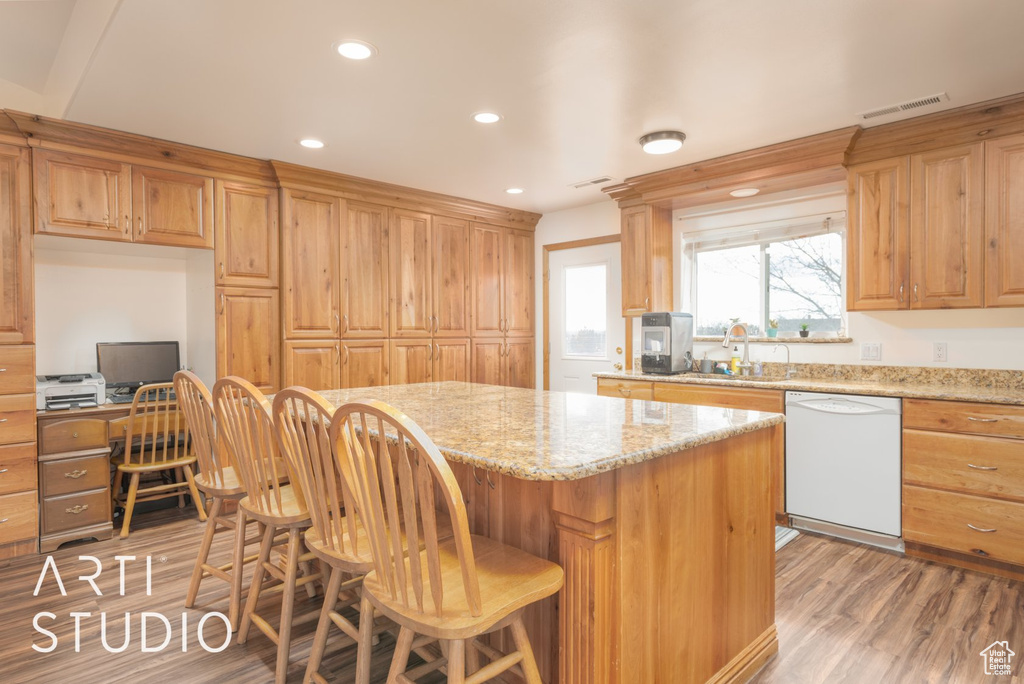 Kitchen with dishwasher, light wood-style floors, a center island, recessed lighting, and a breakfast bar area